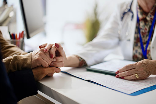 a doctor holding a patient's hands